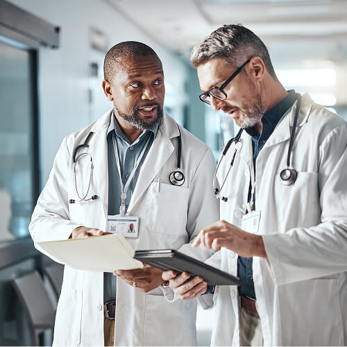 man with laptop open speaks on the phone